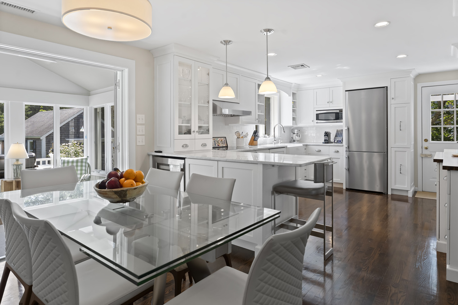 21 Kitts Field Circle Edgartown, MA 02539 - Photo 9 of 34 a kitchen with stainless steel appliances kitchen island granite countertop a table chairs in it and wooden floors