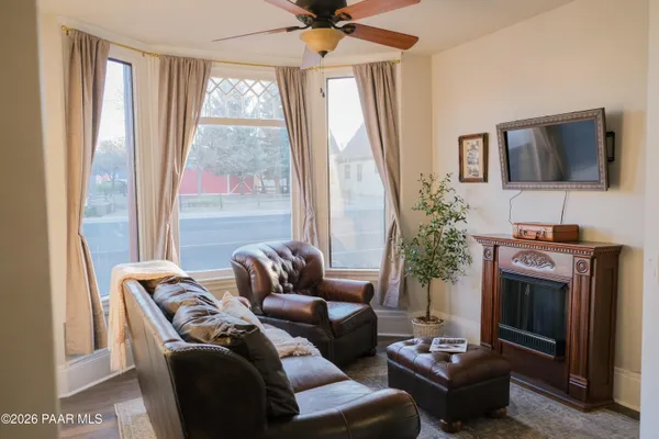 a living room with furniture a large window and a fireplace
