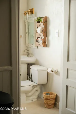 a bathroom with a toilet and a shower curtain
