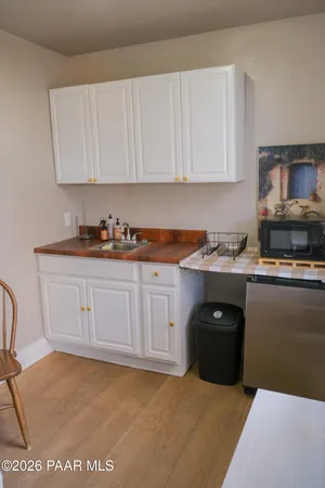 a kitchen with granite countertop white cabinets and stainless steel appliances