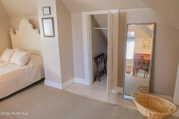 a living room with furniture and a dining table with wooden floor