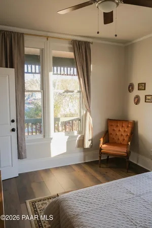 a bedroom with a bed and a large window