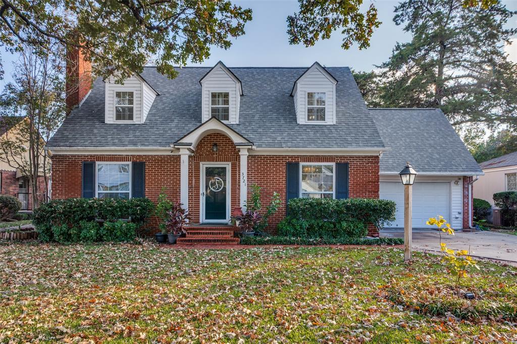 front view of brick house with a yard