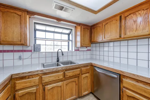 a kitchen with a sink and cabinets