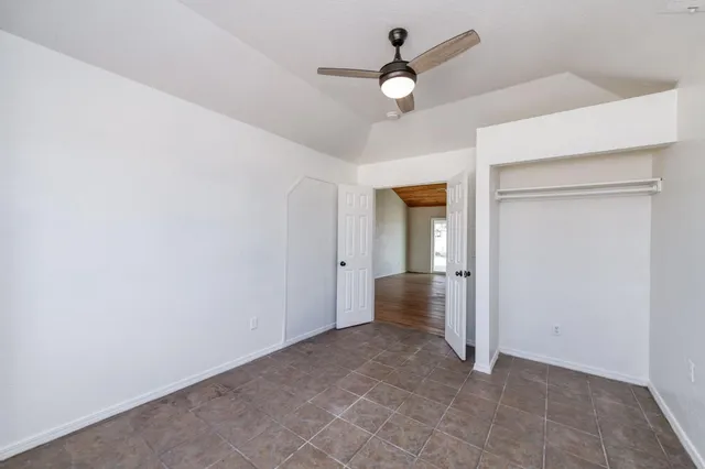 a view of a livingroom with a ceiling fan and window
