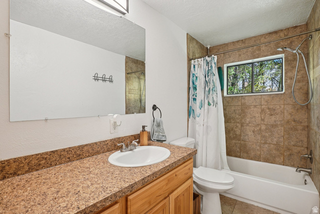 645 Swenson Avenue, Unit 3 Springville, UT 84663 - Photo 5 of 9 Full bathroom featuring vanity, shower / bath combo, a textured ceiling, and light tile patterned flooring