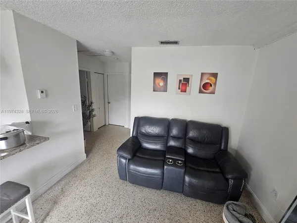 a view of entryway with livingroom and natural light
