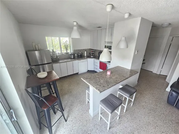 a kitchen with a table chairs and entryway