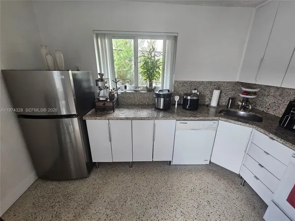 a kitchen with a sink a window and appliances