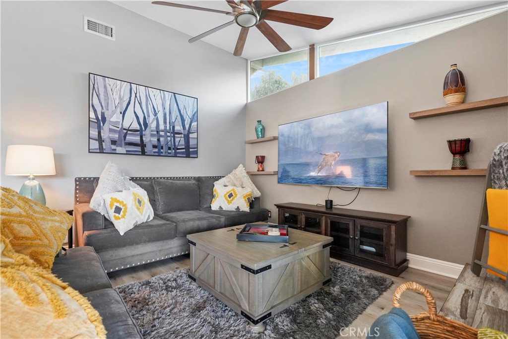 20448 Eccles Street Winnetka, CA 91306 - Photo 16 of 54 a living room with furniture a rug and a flat screen tv