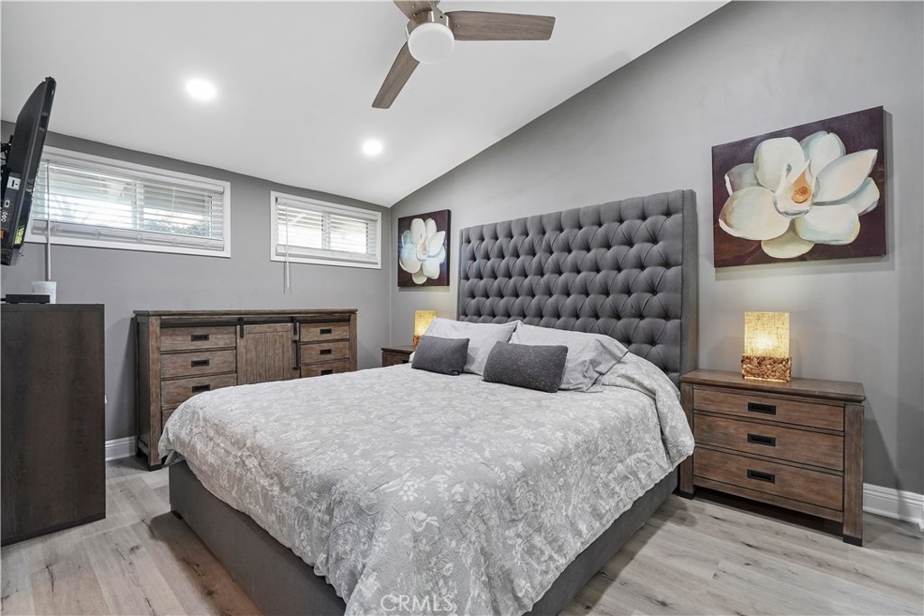 20448 Eccles Street Winnetka, CA 91306 - Photo 20 of 54 a bedroom with a bed and dresser with mirror