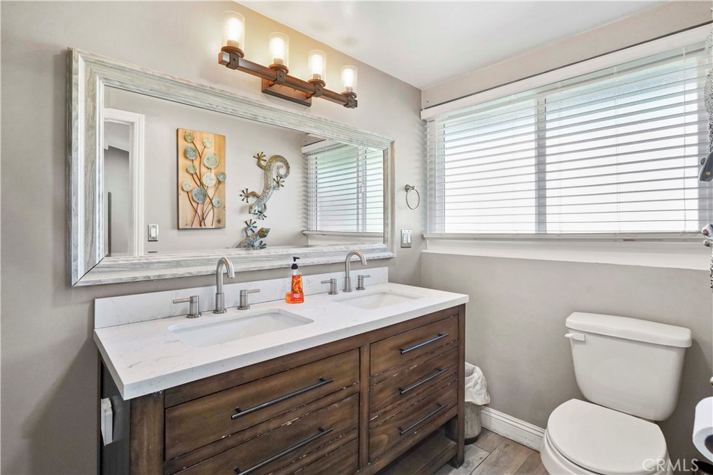 20448 Eccles Street Winnetka, CA 91306 - Photo 23 of 54 a bathroom with a toilet sink and mirror