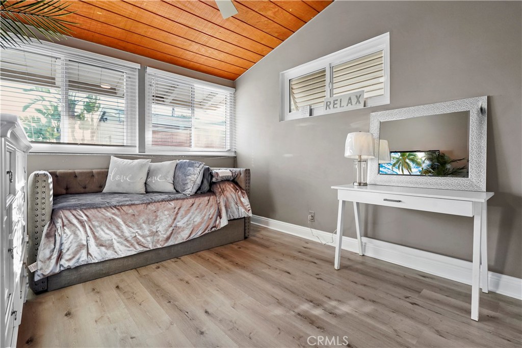 20448 Eccles Street Winnetka, CA 91306 - Photo 27 of 54 a bedroom with a bed and a dresser next to a window