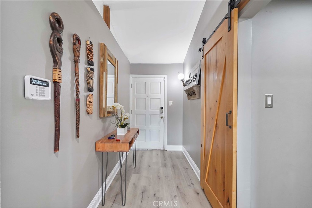 20448 Eccles Street Winnetka, CA 91306 - Photo 6 of 54 a hallway with furniture and wooden floor