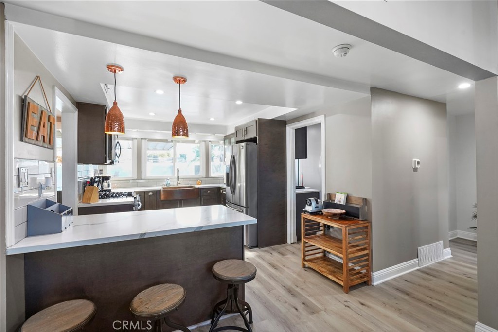 20448 Eccles Street Winnetka, CA 91306 - Photo 8 of 54 a kitchen with a sink appliances and cabinets