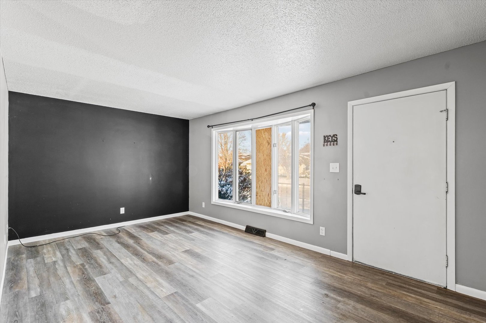 1058 North Drive Rantoul, IL 61866 - Photo 6 of 37 a view of an empty room with a window