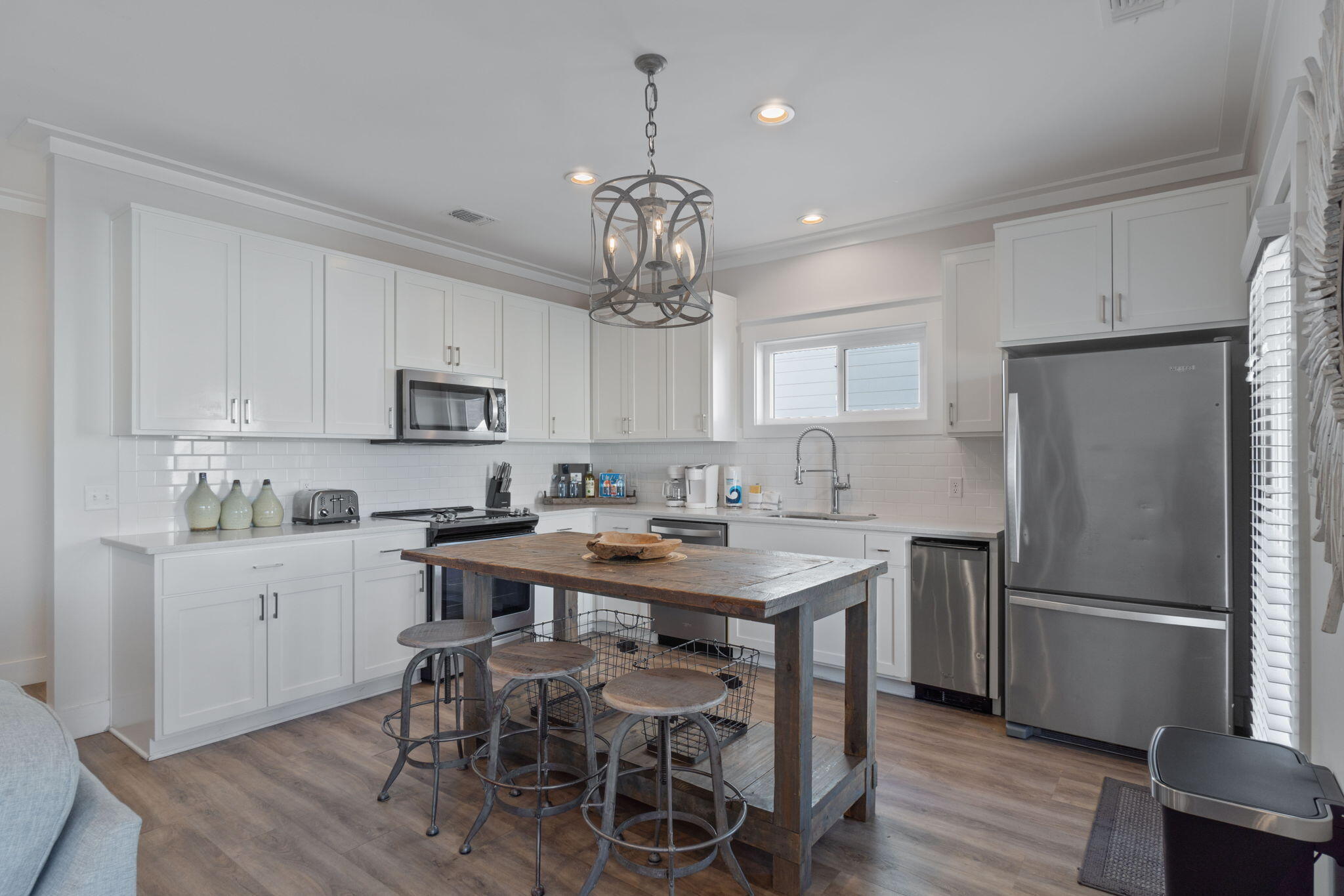 10 Blue Surf Lane Miramar Beach, FL 32550 - Photo 13 of 60 a kitchen with stainless steel appliances a table chairs refrigerator and cabinets