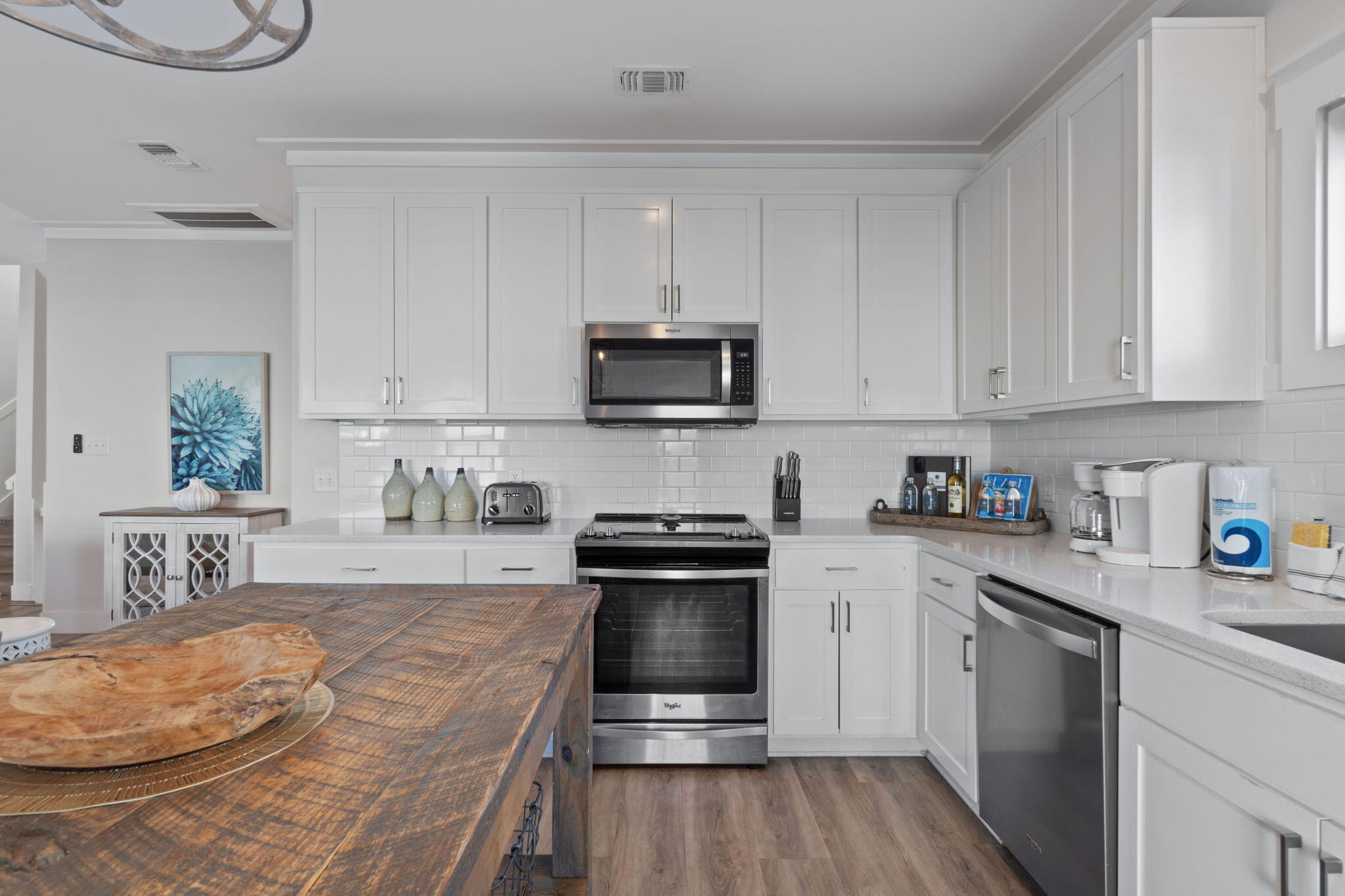 10 Blue Surf Lane Miramar Beach, FL 32550 - Photo 14 of 60 a kitchen with granite countertop a stove top oven a sink dishwasher and white cabinets with wooden floor