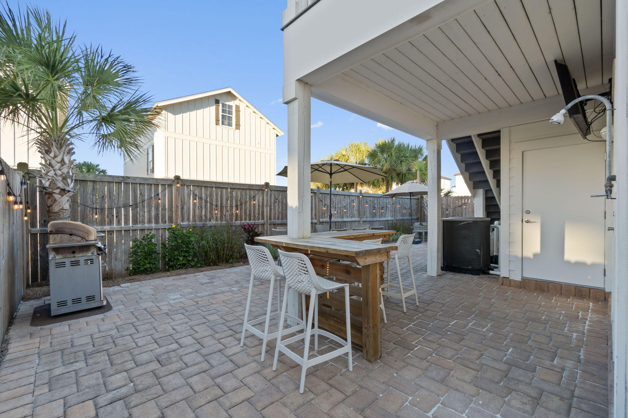 10 Blue Surf Lane Miramar Beach, FL 32550 - Photo 43 of 60 a view of a chairs and table in the back yard of the house