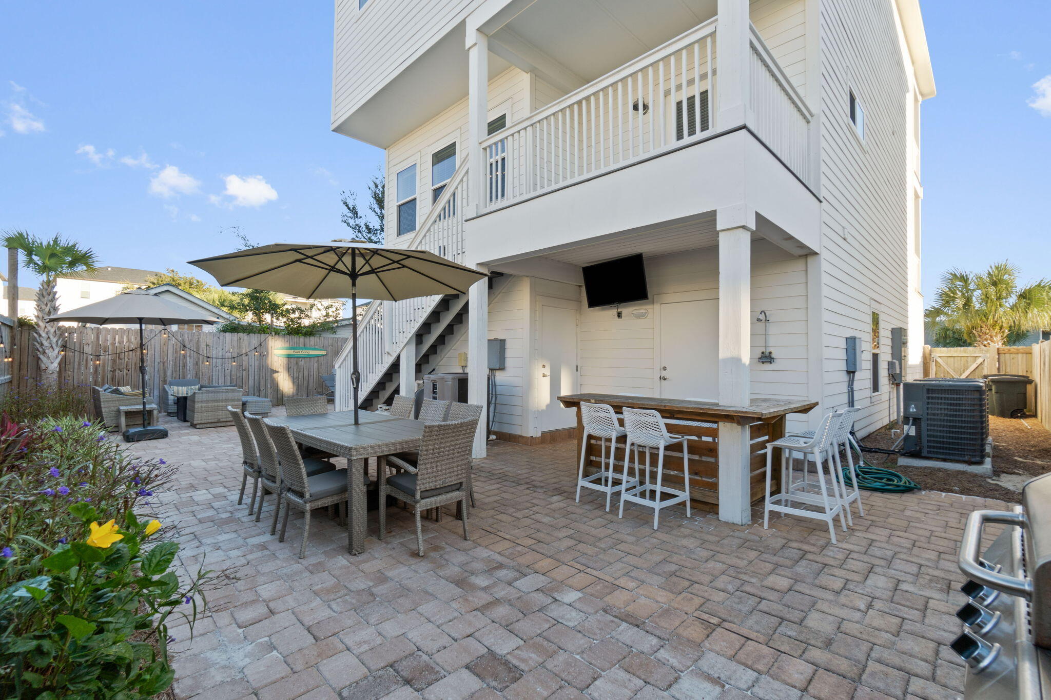 10 Blue Surf Lane Miramar Beach, FL 32550 - Photo 44 of 60 a view of a patio with a table and chairs under an umbrella