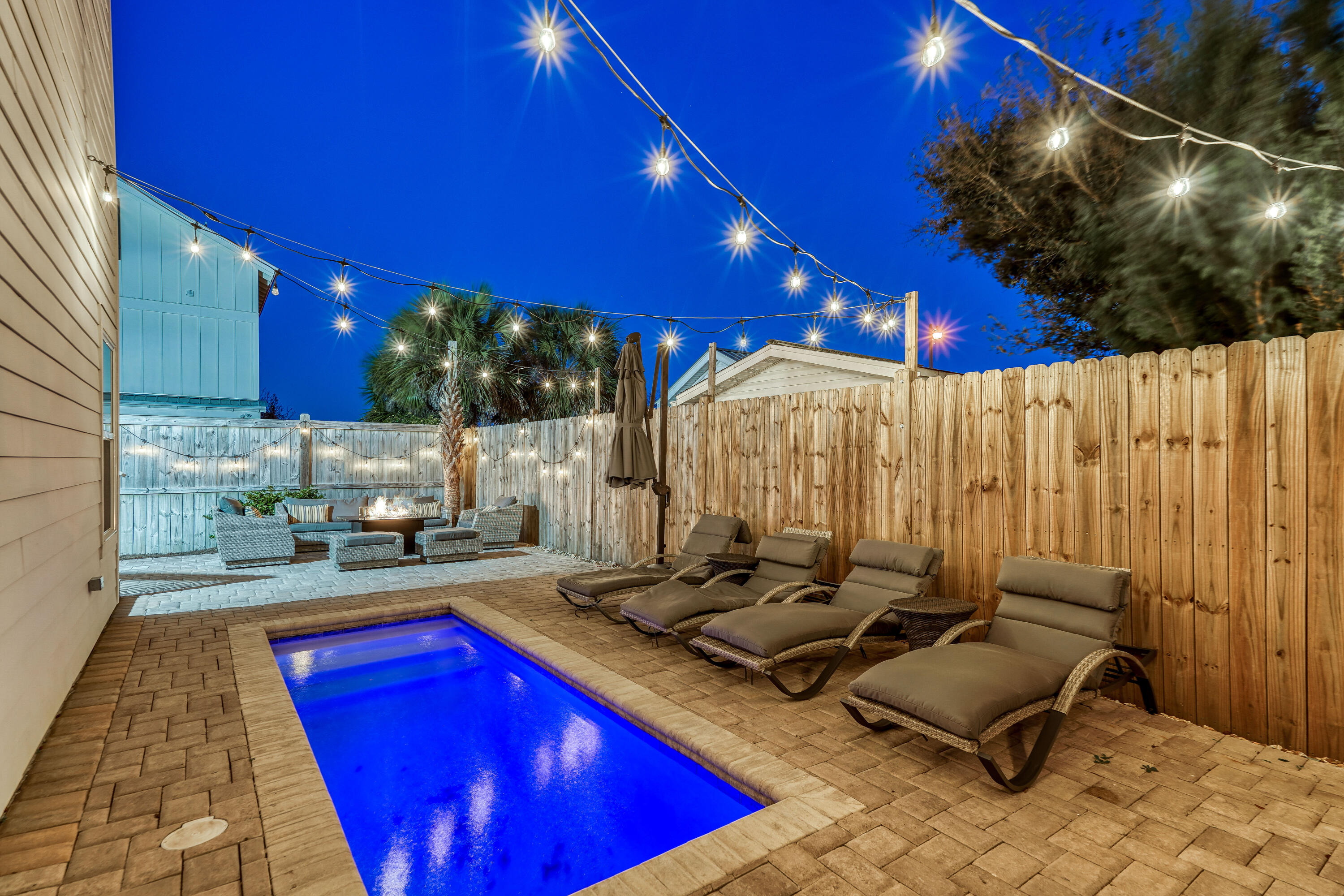 10 Blue Surf Lane Miramar Beach, FL 32550 - Photo 5 of 60 a kitchen with stainless steel appliances granite countertop a red stove top oven a dining table and chairs with wooden floor