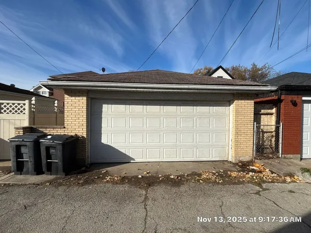 a black car parked in front of a house