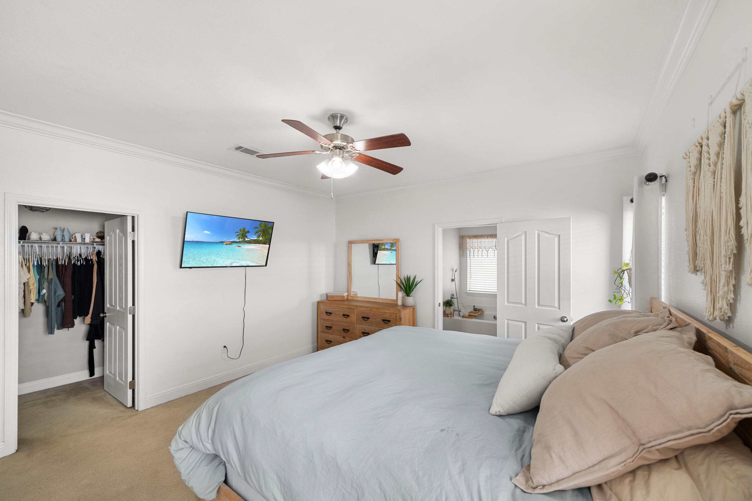 486 Fanny Ann Way Freeport, FL 32439 - Photo 15 of 58 a bedroom with a bed and a chandelier