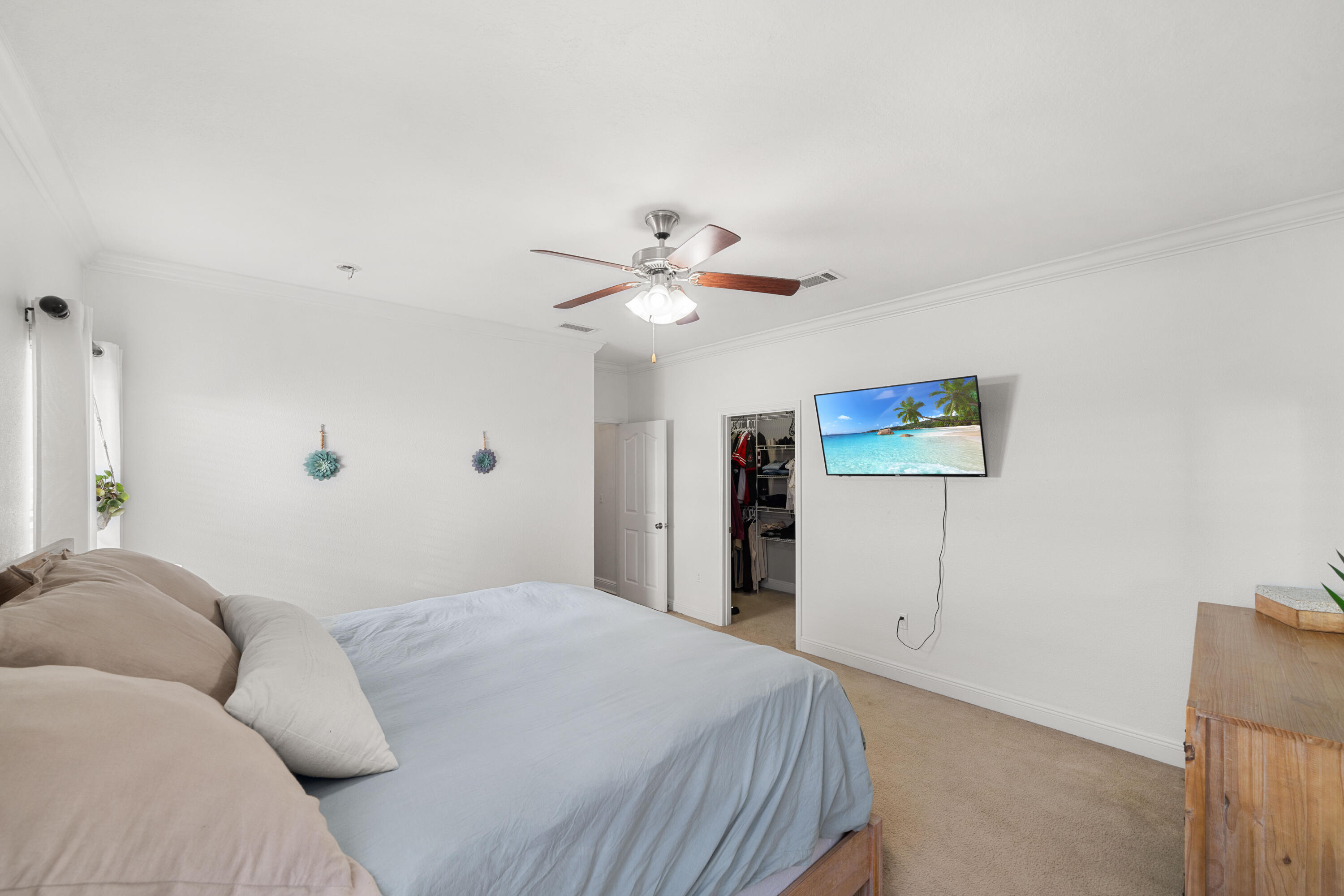 486 Fanny Ann Way Freeport, FL 32439 - Photo 18 of 58 a bedroom with a large bed and a ceiling fan