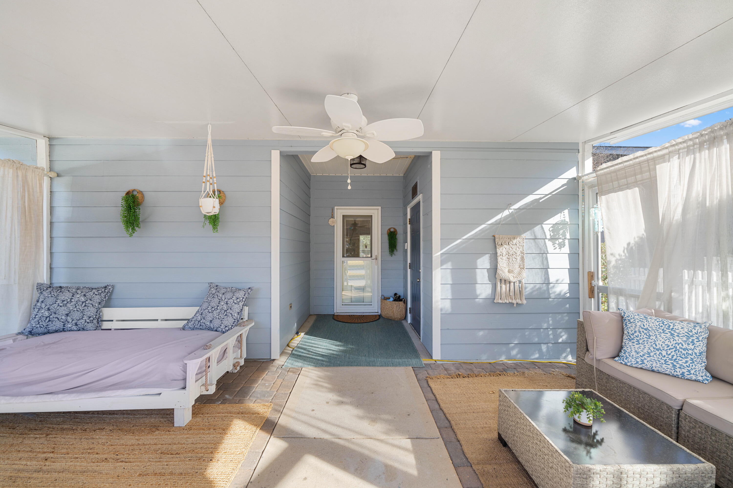 486 Fanny Ann Way Freeport, FL 32439 - Photo 29 of 58 a spacious bedroom with a bed a chandelier and glass door