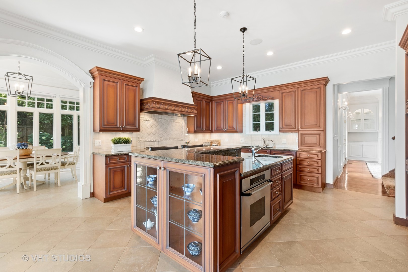 738 Tower Road Winnetka, IL 60093 - Photo 23 of 58 a kitchen with stainless steel appliances granite countertop a stove and a view of living room