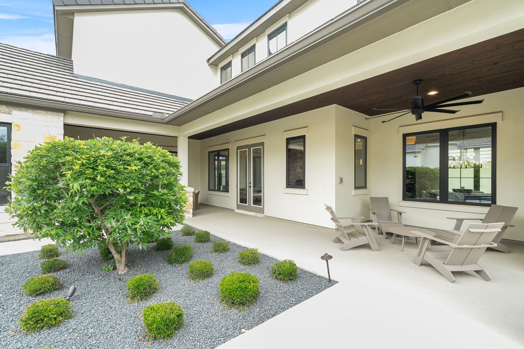 1106 Flint Ridge Trail Georgetown, TX 78628 - Photo 28 of 38 A spacious covered patio invites relaxation, complemented by minimalist landscaping and modern outdoor seating.