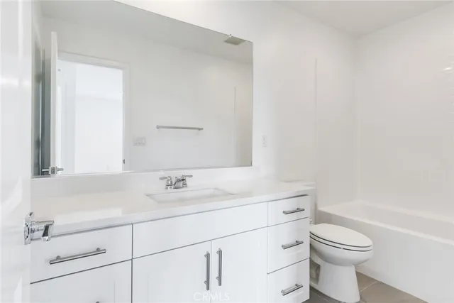 a bathroom with a sink a toilet and a bathtub