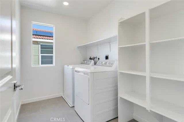 a utility room with cabinets washer and dryer