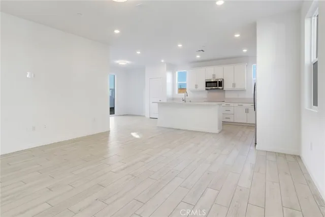 a view of kitchen with stainless steel appliances refrigerator microwave and stove