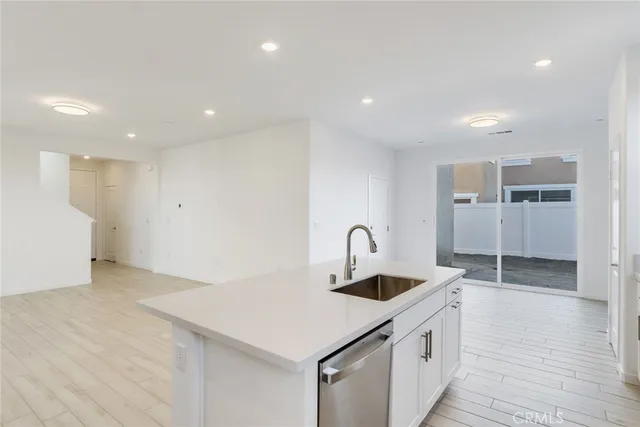 a kitchen with a sink a counter space and appliances