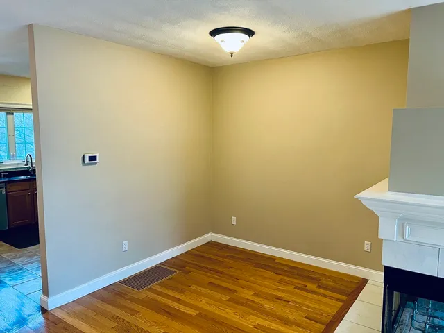a view of a room with wooden floor and glass door