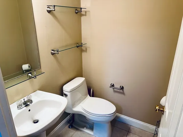 a bathroom with a sink mirror and toilet