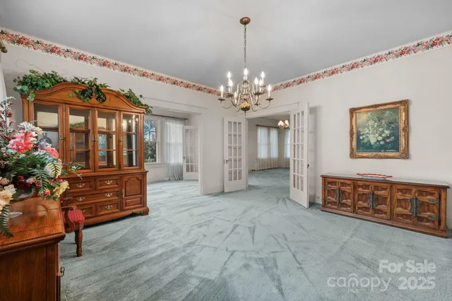 a view of a living room and chandelier