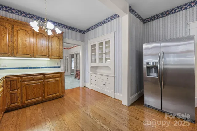 a kitchen with stainless steel appliances granite countertop a refrigerator and a stove top oven