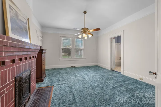 a view of a livingroom with wooden floor and staircase