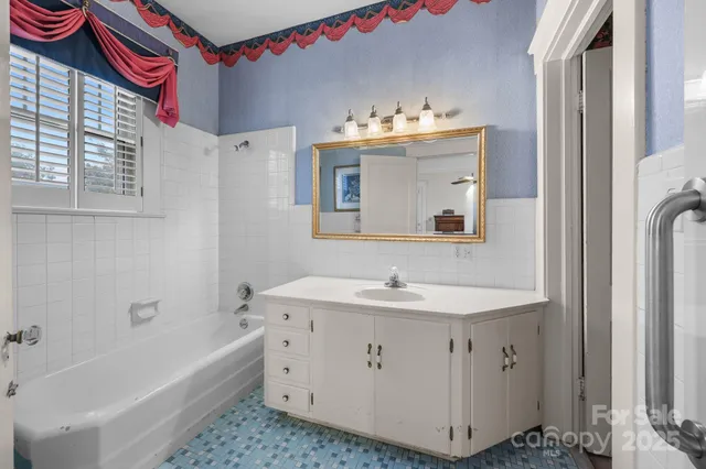 a bathroom with a sink a vanity and a mirror