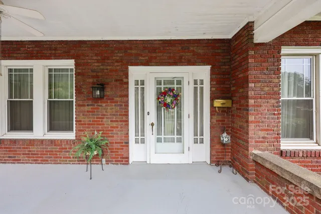 a view of a brick house with a large windows