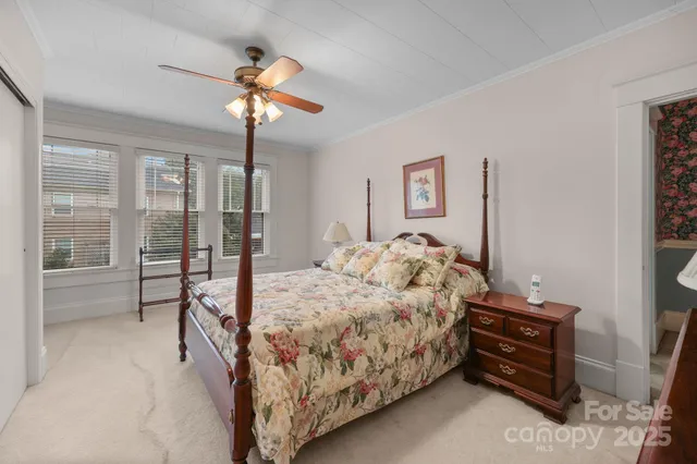 a bed room with a bed and a chandelier