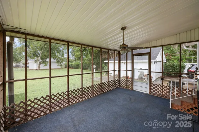 a view of a porch with wooden floor and fence