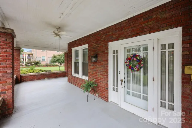 a view of a porch with furniture and garden