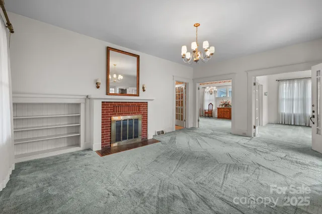 a view of an empty room with a fireplace