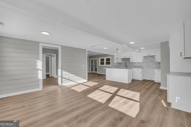 a view of a living room kitchen and a wooden floor