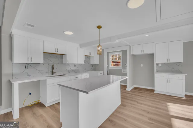 a kitchen with a sink stove and cabinets
