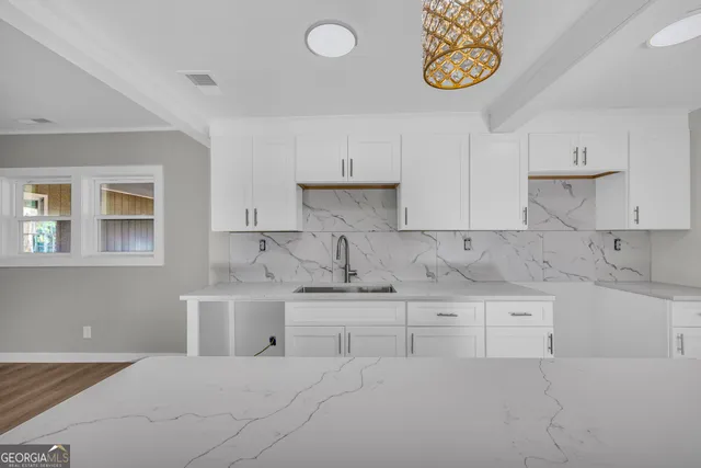 a kitchen with stainless steel appliances granite countertop a sink and a stove