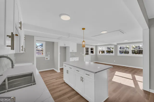 a spacious bathroom with a granite countertop sink and a large mirror